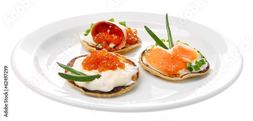 Pancakes with red caviar and salmon, isolated on white