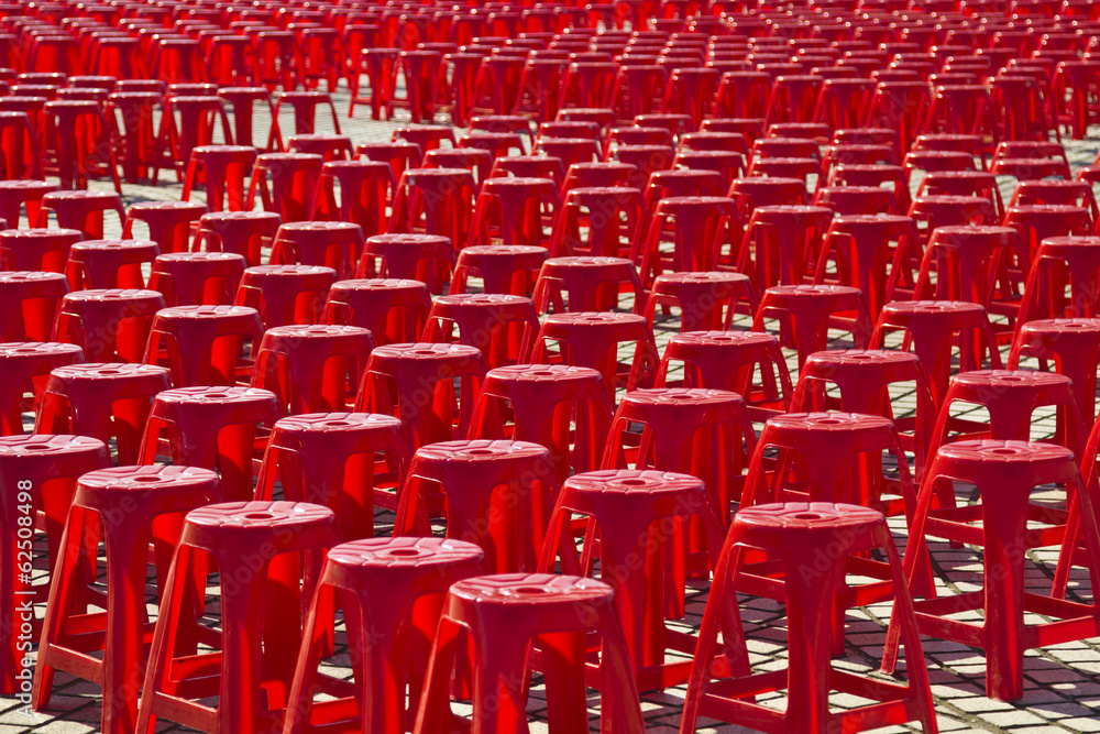 Fototapeta premium Empty red plastic chairs