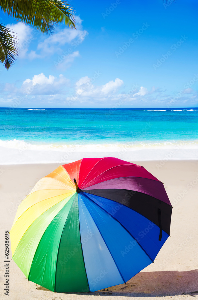 Summer background with rainbow umbrella