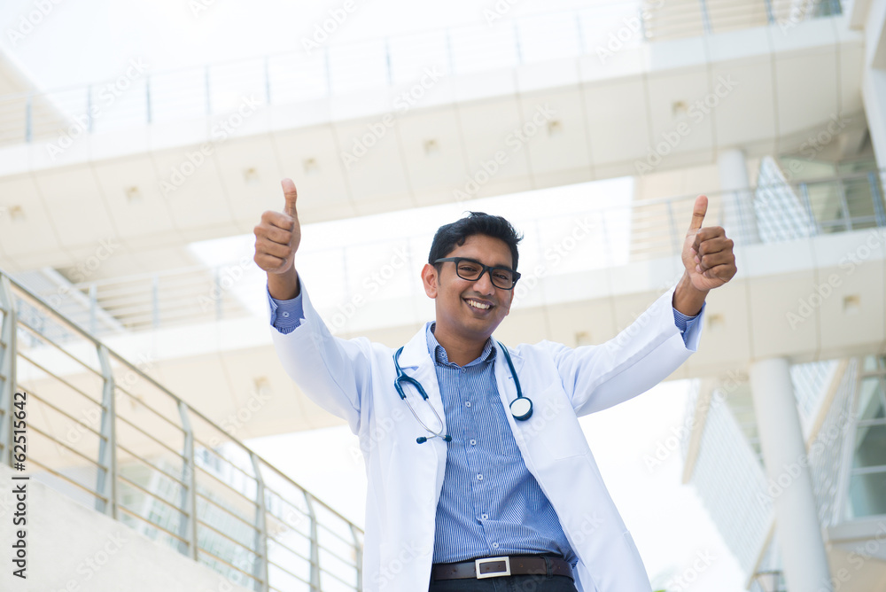 indian male doctor with two thumbs up indian male doctor with two thumbs up