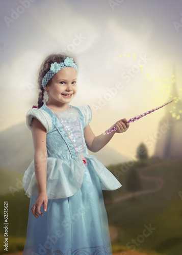 Obraz na plátne Girl with a magic wand in her hand, fairy tale landscape