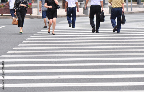 business people walking at zebra crossing