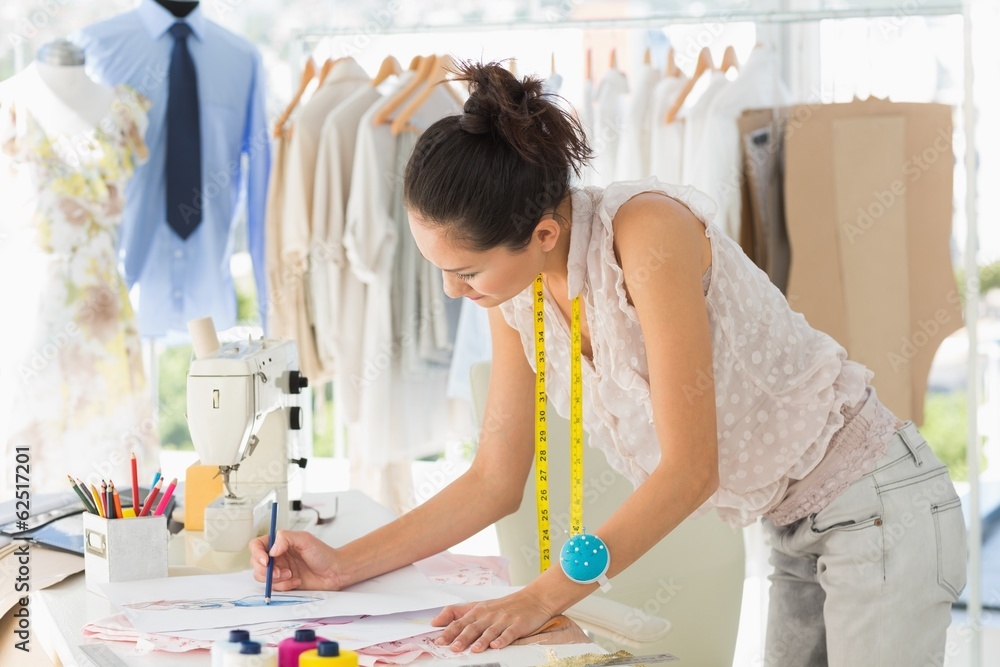 Female fashion designer working on her designs Female fashion designer working on her designs