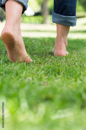 Woman walking on grassy land