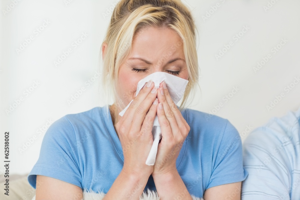 Closeup of a young woman suffering from cold Closeup of a young woman suffering from cold