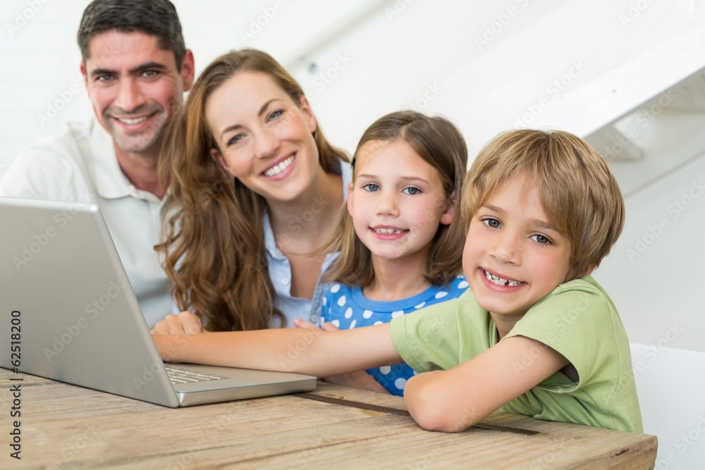 Smiling family using laptop Smiling family using laptop