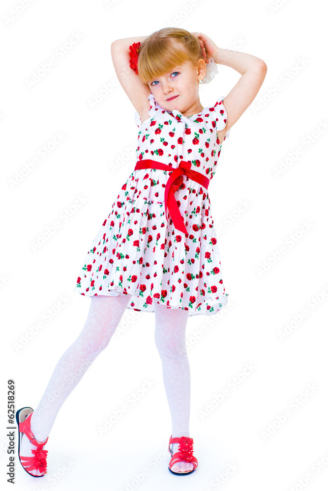 Charming little girl standing leg thrust forward and have fun lo Charming little girl standing leg thrust forward and have fun lo