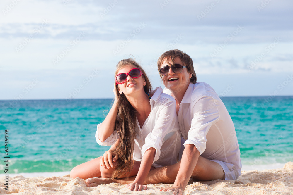 front view of happy young couple on beach front view of happy young couple on beach