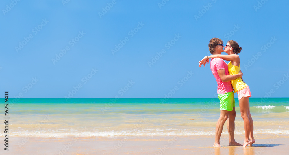 panoramic view of happy young couple on tropical beach
