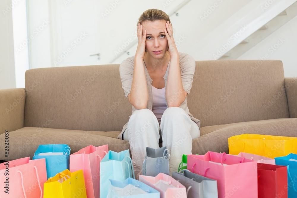 Ταπετσαρία Regretful woman looking at many shopping bags on the couch