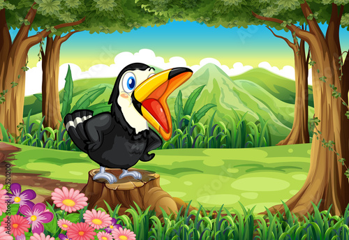 A big black bird above the stump at the forest