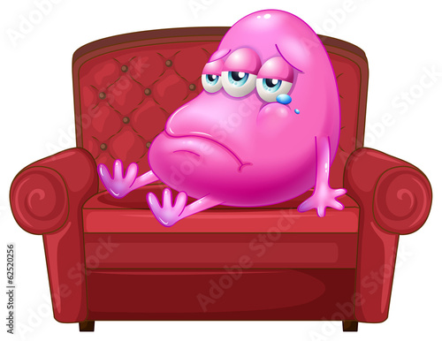 A crying monster sitting on a red sofa