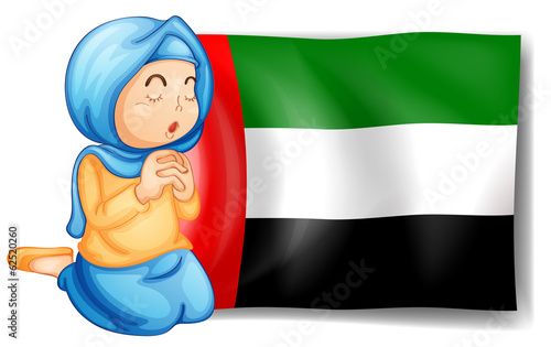 A girl in front of the United Arab Emirates flag