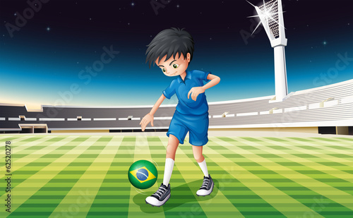 A soccer player at the field with the flag of Brazil