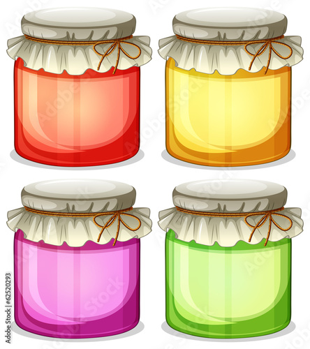 Four colorful jars that are  tightly covered