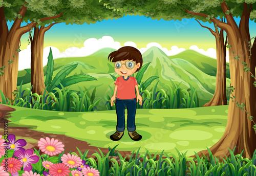 A forest with a boy wearing glasses