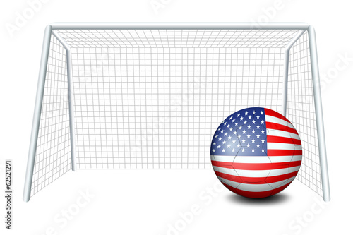 A soccer ball near the net with the flag of the United States