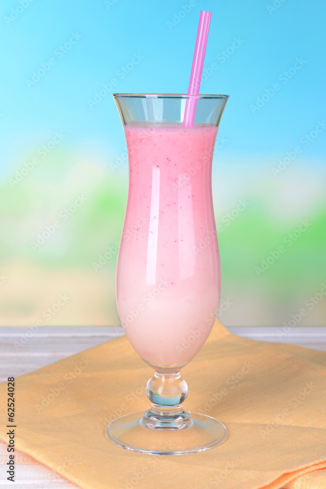 Milk shake on table on light blue background Milk shake on table on light blue background