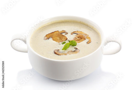 Mushroom soup in white bowl,, on plate, isolated on white