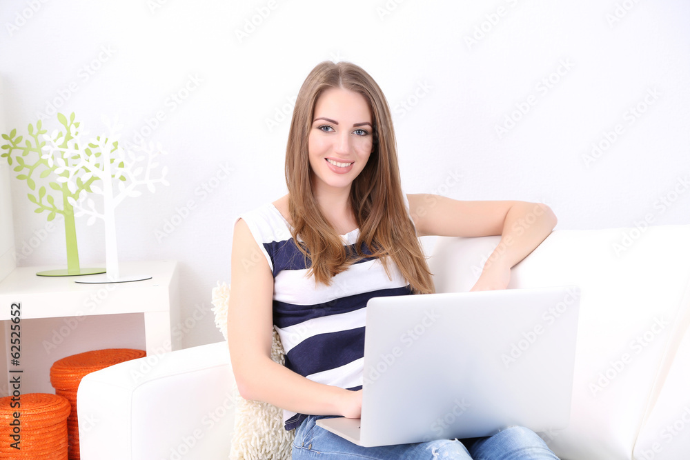Young woman resting with laptop on sofa at home Young woman resting with laptop on sofa at home