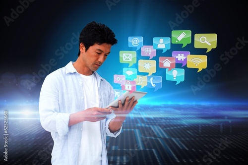 Casual man using tablet with app icons