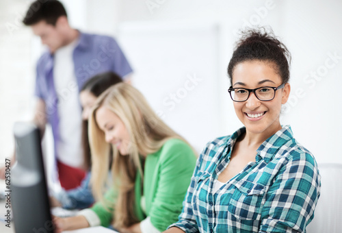 student with computer studying at school