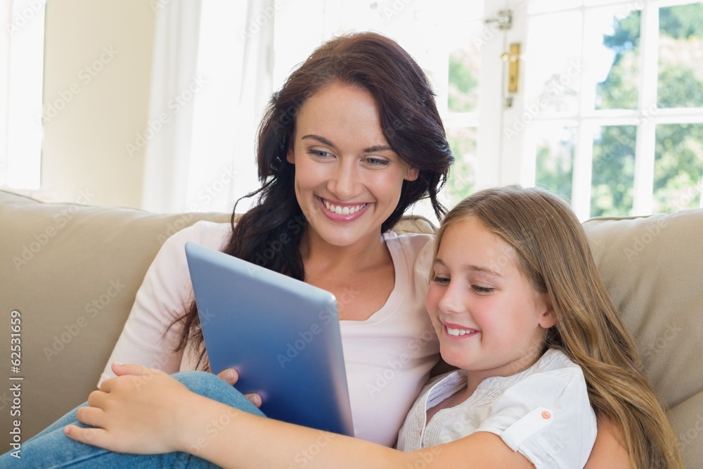 Mother and daughter using digital tablet in house Mother and daughter using digital tablet in house