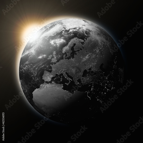 Fototapeta Naklejka Na Ścianę i Meble -  Sun over Europe on dark planet Earth