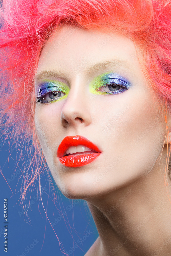 Portrait of beautiful girl with pink hair and colorful make-up