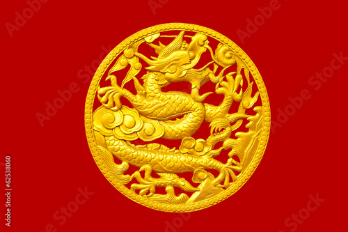 Golden Chinese dragon on red wood background