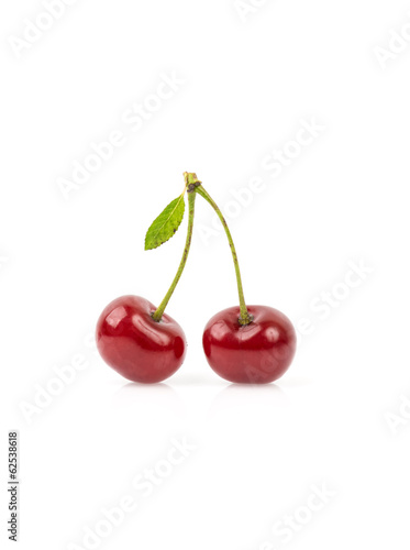 Cherry with leaf isolated on white.