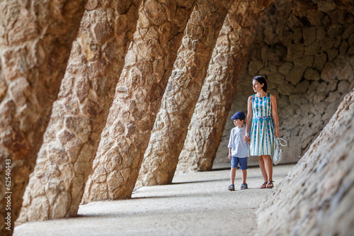 Young mother and her son walking Park Guell