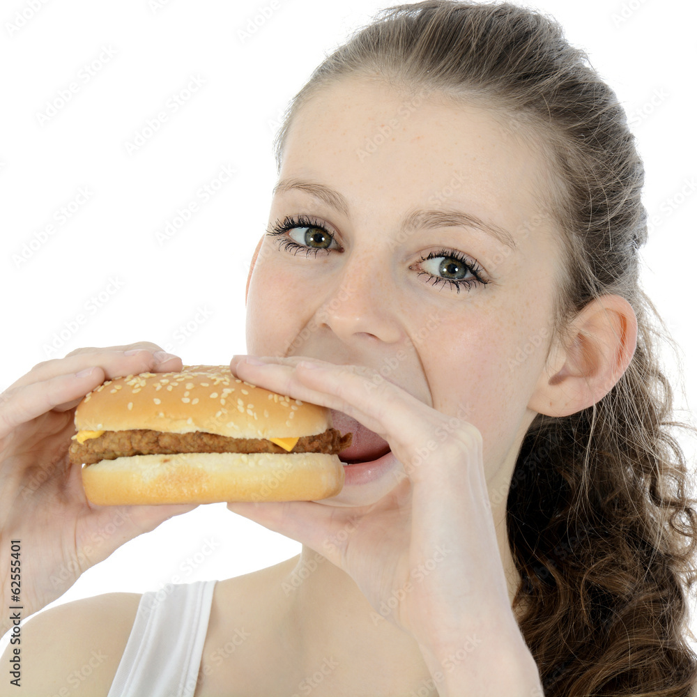 Teenager isst Cheeseburger als Snack Teenager isst Cheeseburger als Snack