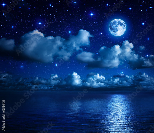 super moon in starry sky with clouds and sea