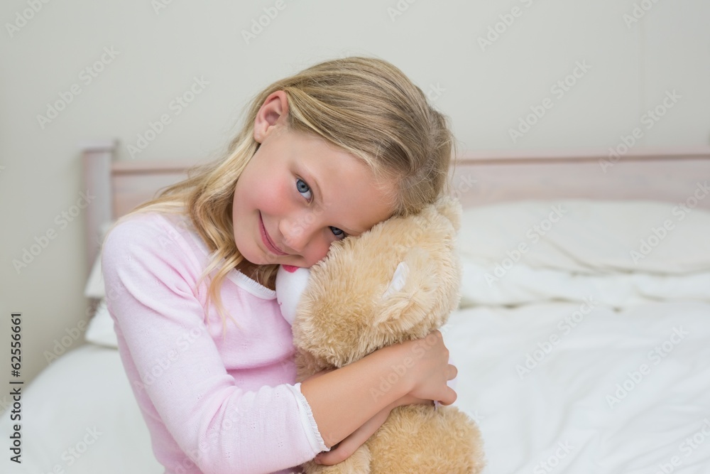 Young girl embracing stuffed toy in bed Young girl embracing stuffed toy in bed