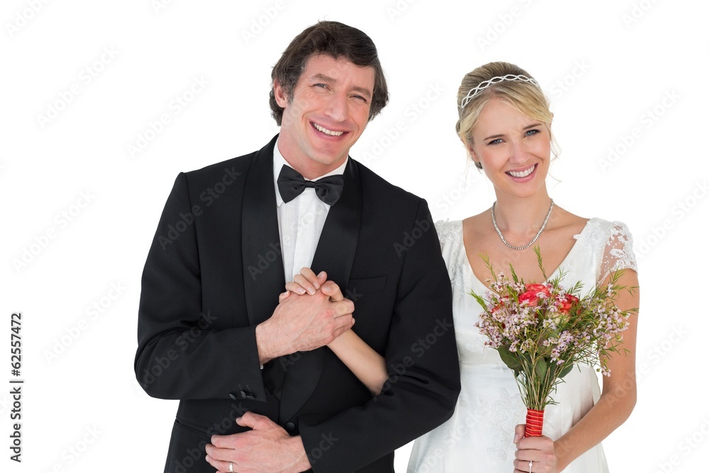 Bride and groom holding hands over white background