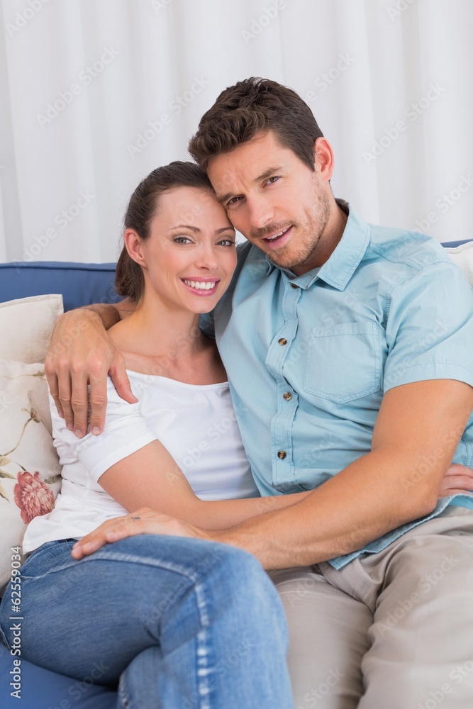 Portrait of a loving couple sitting on couch Portrait of a loving couple sitting on couch