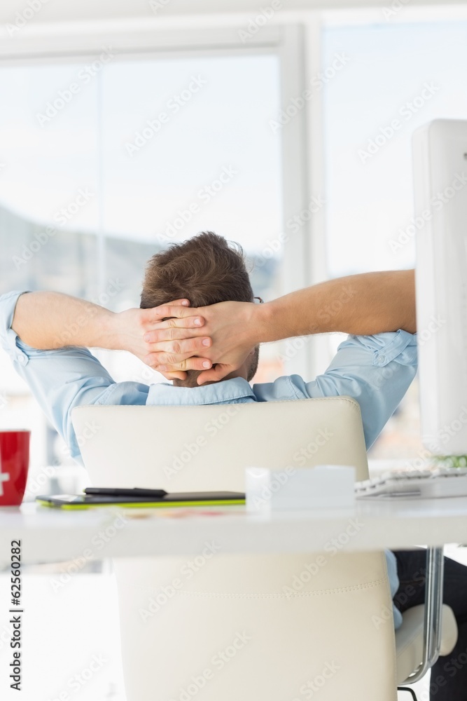 Obraz premium Young designer relaxing at his desk