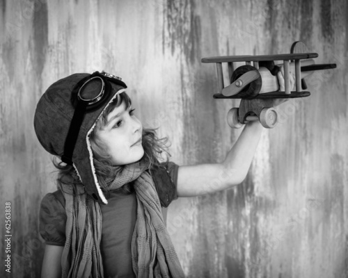 Happy kid playing with toy airplane