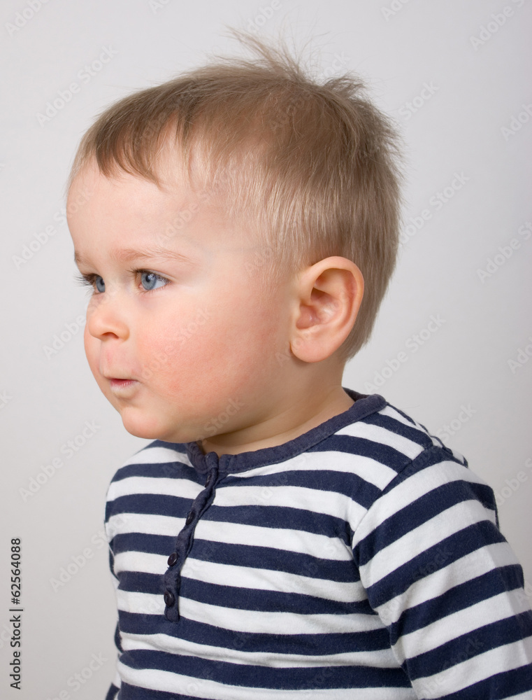 Serious little boy looking forward Serious little boy looking forward