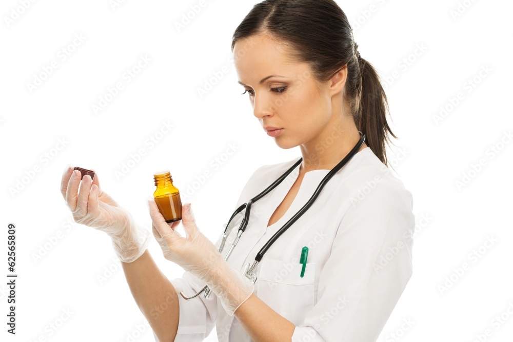 Young doctor woman reading prescription on a vial Young doctor woman reading prescription on a vial