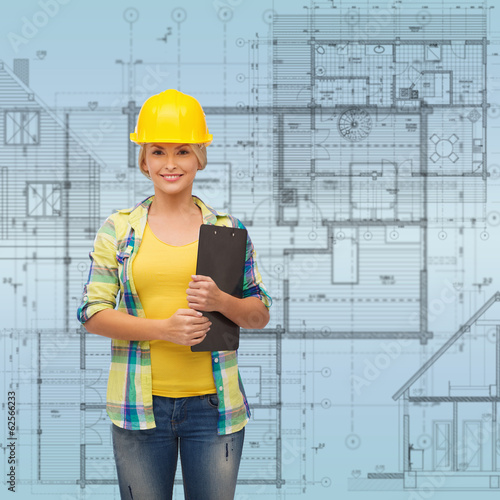 smiling woman in helmet with clipboard