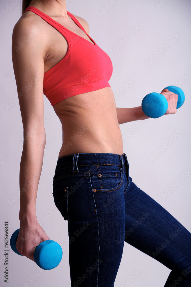 Young beautiful fitness girl exercising with dumbbells, Young beautiful fitness girl exercising with dumbbells,