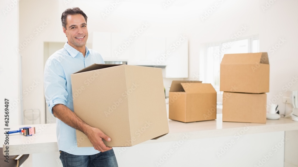 Man carrying boxes in a new house Man carrying boxes in a new house