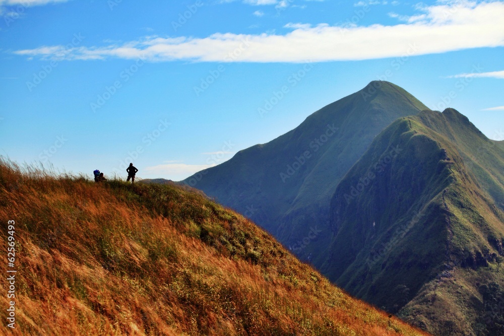 silhouette of people on top of mountain silhouette of people on top of mountain