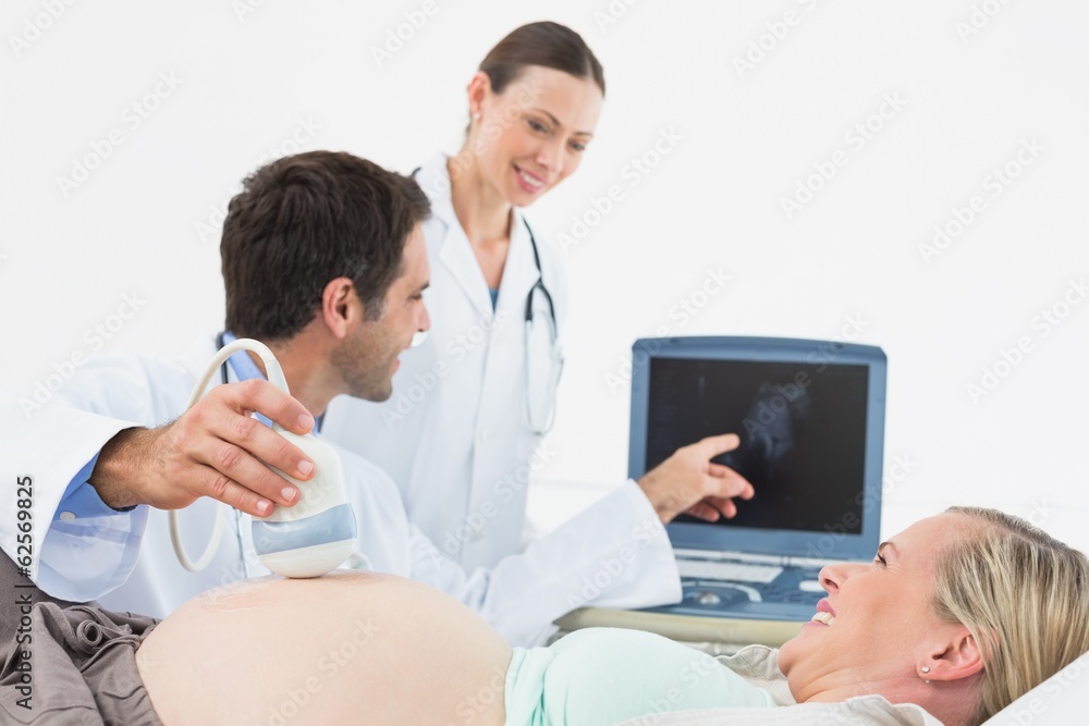 Smiling pregnant blonde having an ultrasound scan Smiling pregnant blonde having an ultrasound scan