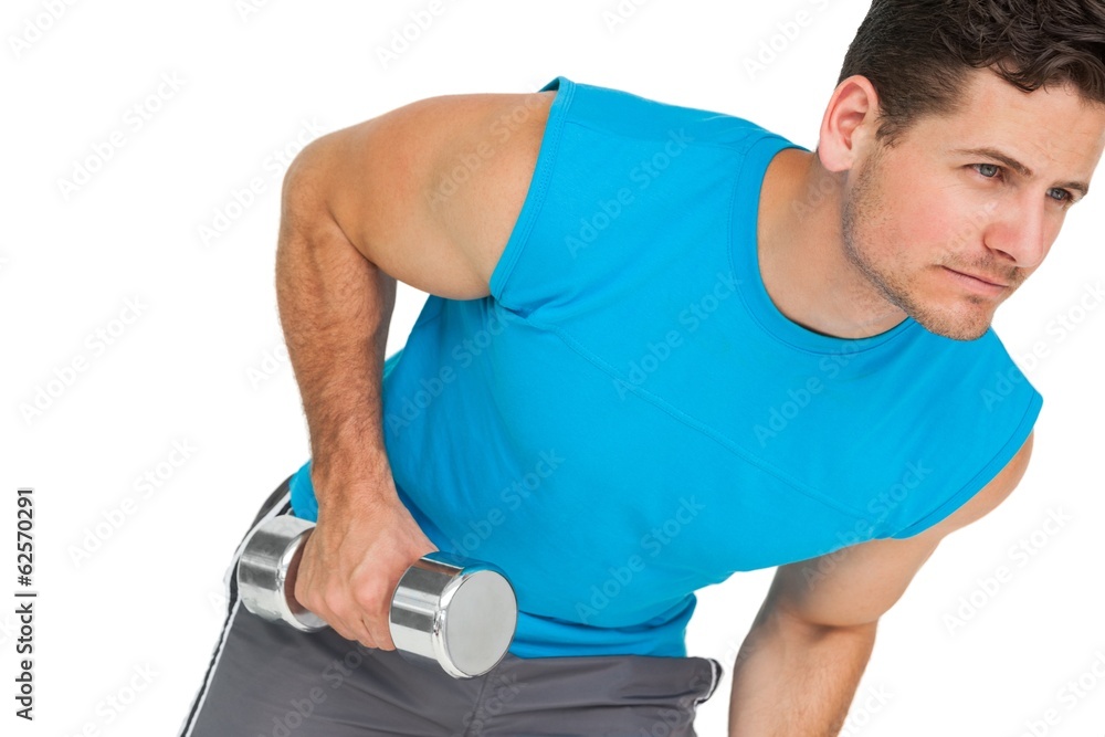 Fit young man exercising with dumbbell Fit young man exercising with dumbbell