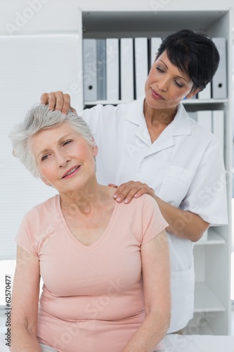 Female chiropractor doing neck adjustment