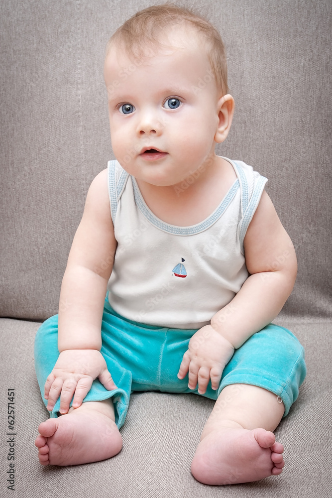 Cute baby boy sitting on the sofa Cute baby boy sitting on the sofa