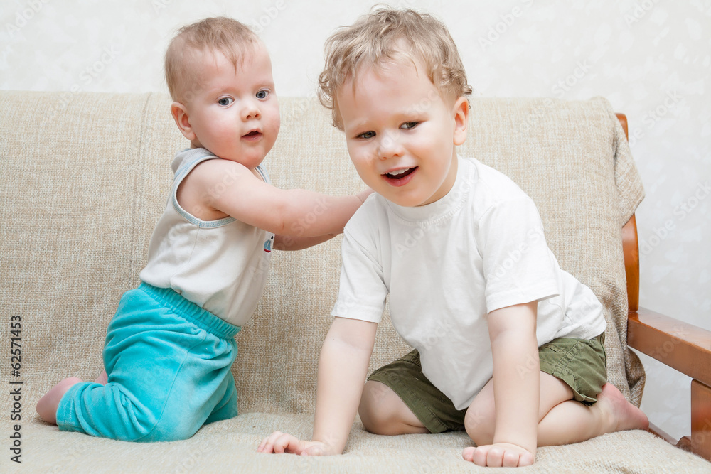 Two little brothers playing on the sofa Two little brothers playing on the sofa